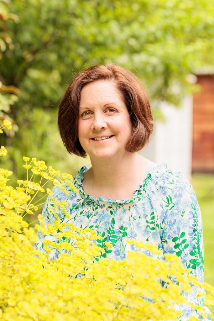 Woman poses with yellow flowers 