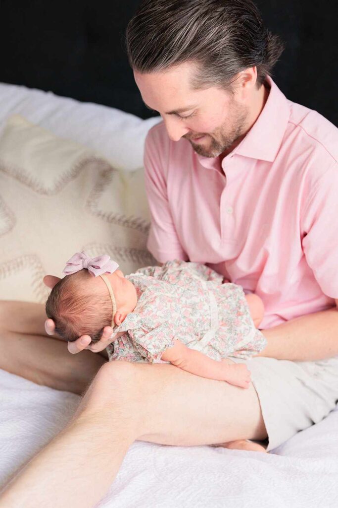 Dad cradles newborn baby during Philadelphia Photo session