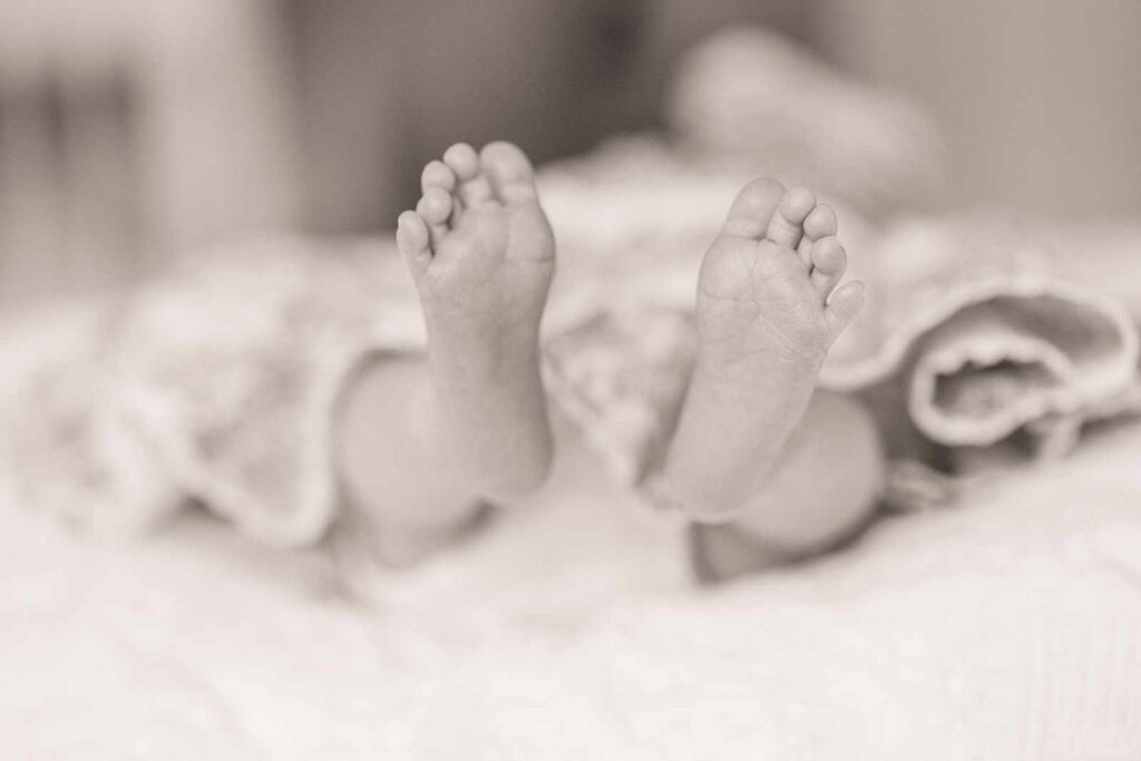 portrait of newborn baby feet during Main Line newborn photo session