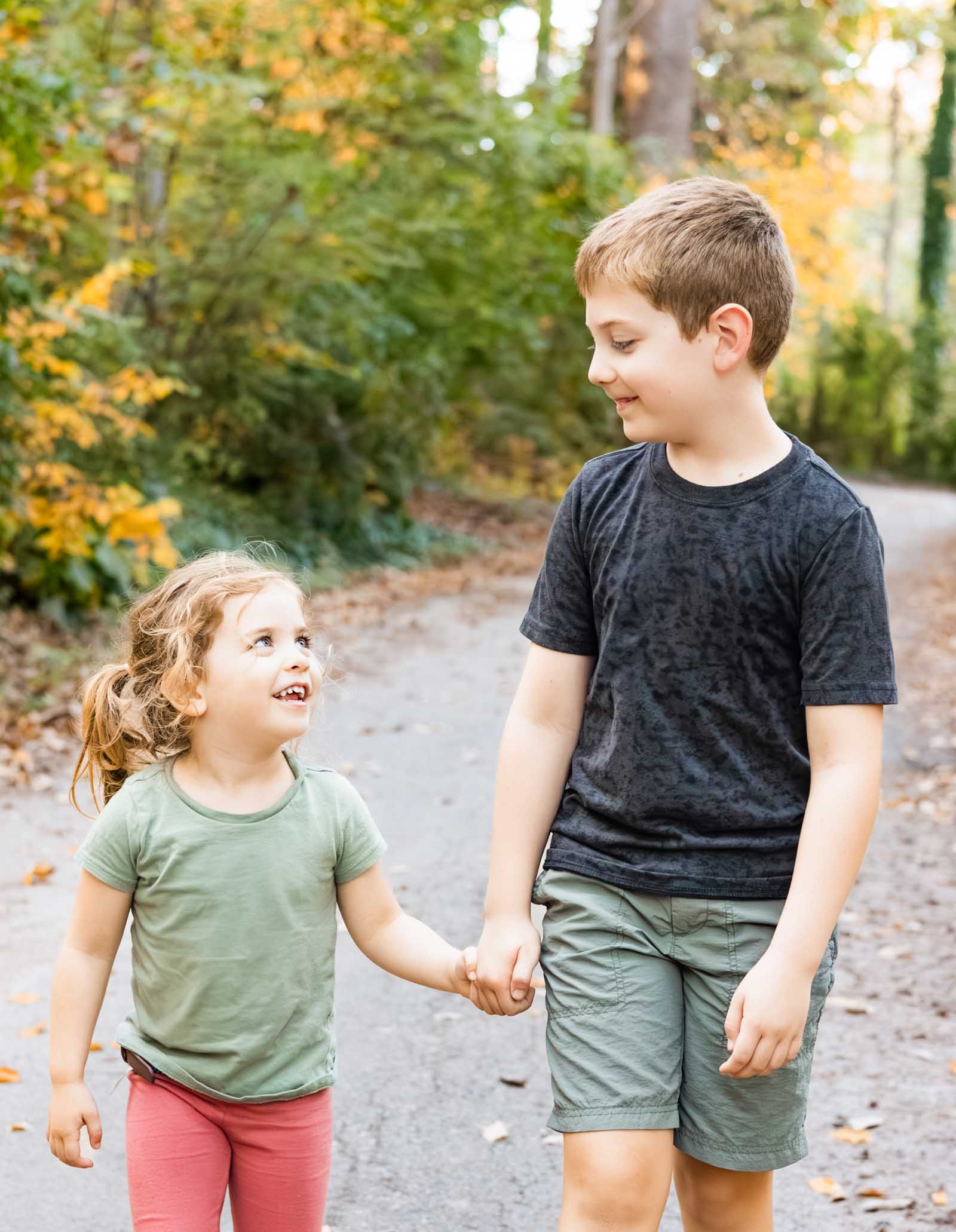 Siblings walk together during fall mini session in Lower Merion, PA