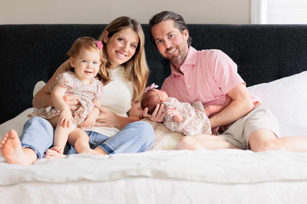 Family poses during newborn photo session in Philadelphia suburbs