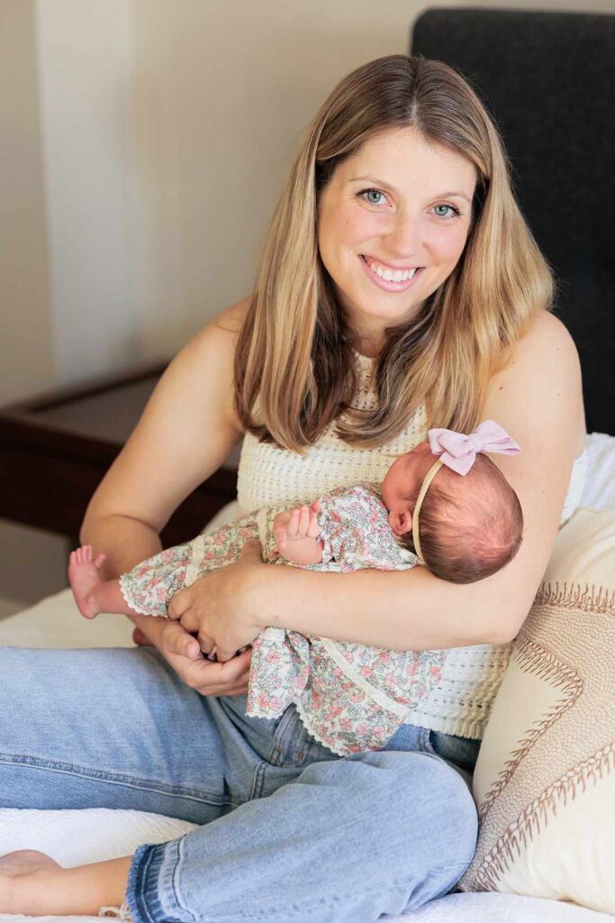 Mother cradles newborn baby during in home newborn photo session, Main Line, PA