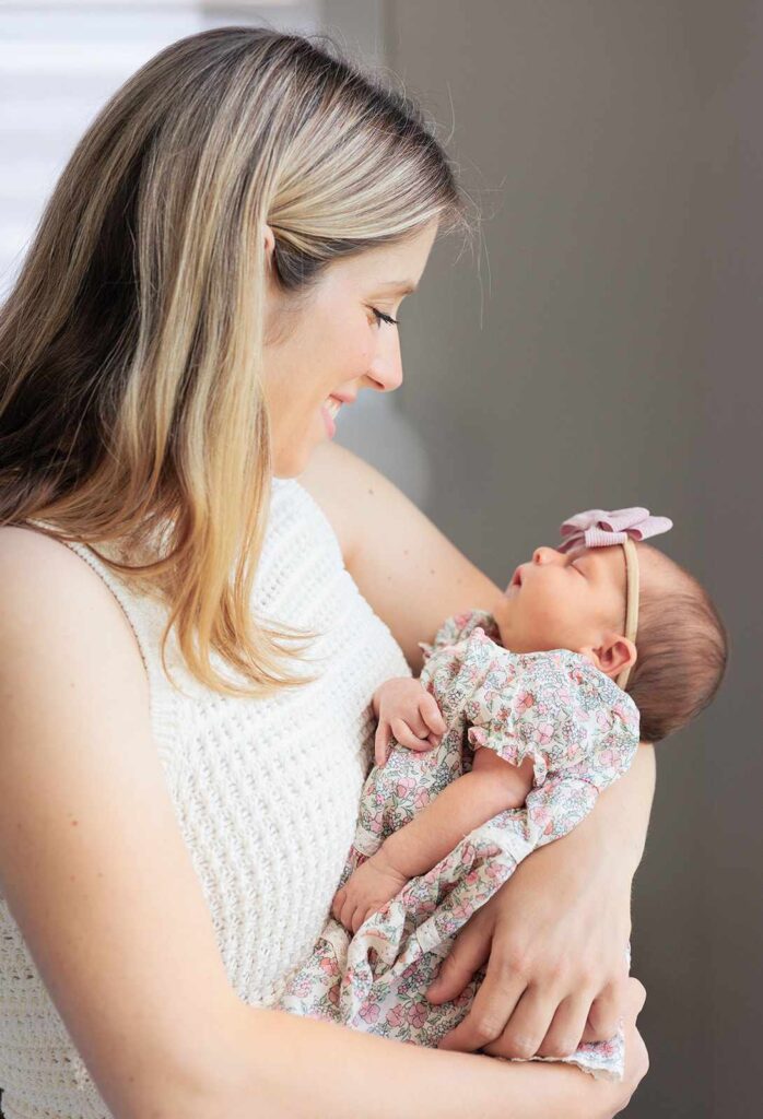 Mom and baby look at each other during Main Line in-home newborn session