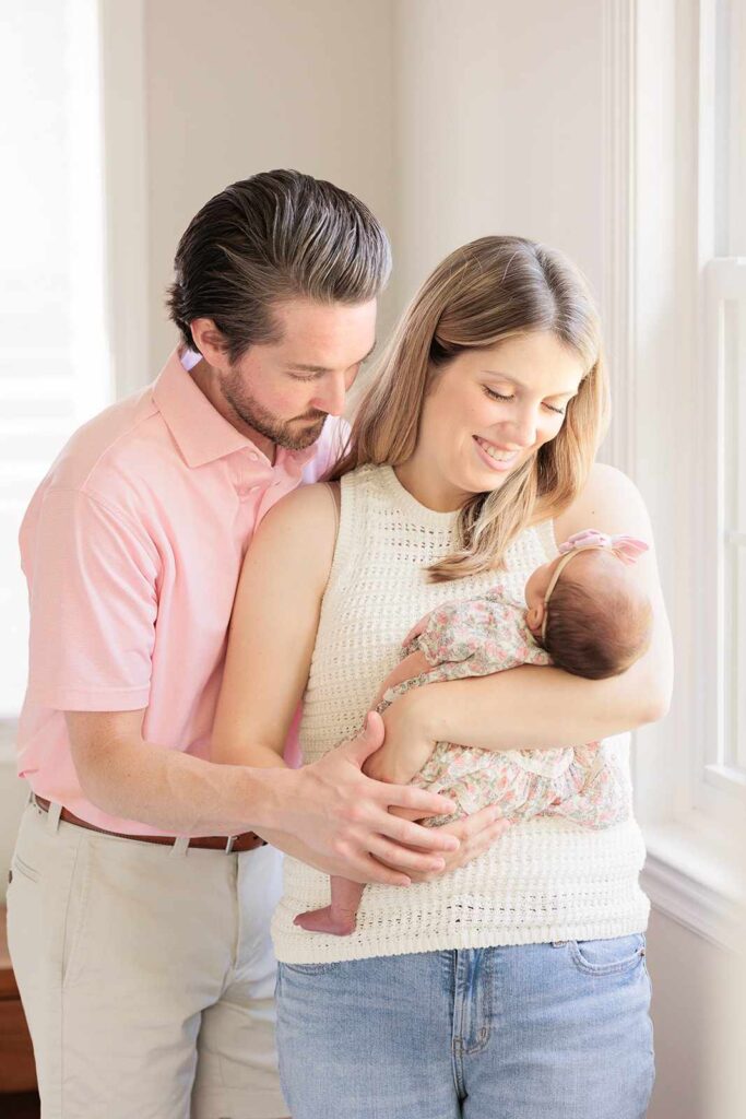 New parents gaze fondly at their newborn. Main Line, PA 