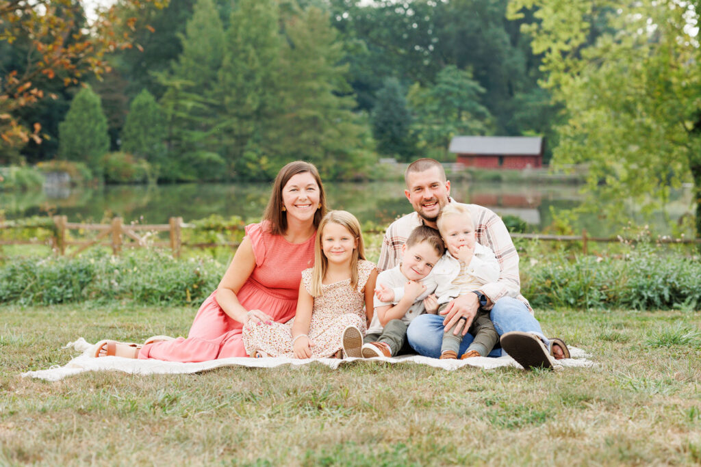 family sits on blanker during fall mini session at Haverford 